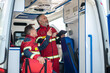 © zinkevych - Experienced paramedical personnel conducting inspection of the ambulance car