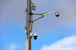 Outdoor surveillance video cameras on a street pole in blue sky. Cctv camera, concept for security, privacy and protection from crime