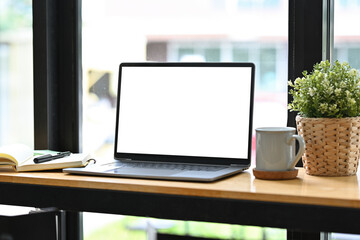Poster - Work space with laptop, Empty screen of laptop, Mock up on the wooden counter bar.