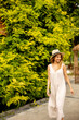 © BGStock72 - Young woman with hat walking in the resort garden