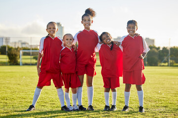 Canvas Print - Girl team, kids on soccer field and sports development for happy girls in group portrait together. Teamwork, football and proud female children from Brazil on grass before football game or training.