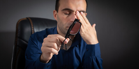 Wall Mural - Caucasian man with eye fatigue. Stress. Eyesight problem