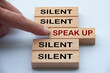 Finger pointing at wooden block with word speak up. Courage to speak up concept