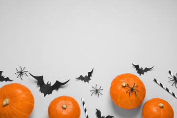 Wall Mural - Flat lay composition with paper bats, spiders, pumpkins and cocktail straws on light grey background, space for text. Halloween decor