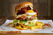 gourmet hamburger with meat, caramelized onion, tomato, bacon and dripping fried egg