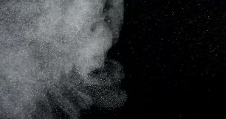 Wall Mural - Dust particles burst on black screen in slow motion. Atmosphere overlay. Filmed with RED camera