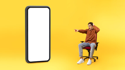 Poster - Man Pointing Finger Aside At Huge Phone Screen, Yellow Background