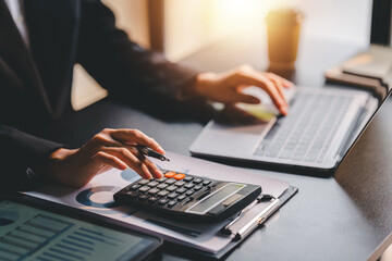 Portrait of a woman working on a tablet computer in a modern office. Make an account analysis report. real estate investment information financial and tax system concepts