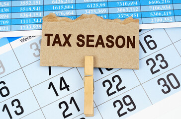 Wall Mural - On the calendar and reporting documents is a cardboard plate with the inscription - TAX SEASON