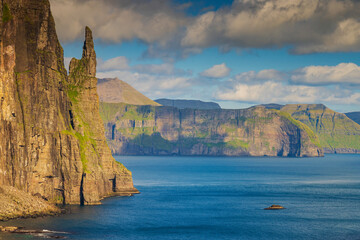 Trøllkonufingur, which means the witch's finger or troll woman's finger, is a 313 m tall monolith on the south-east side of the village Sandavágur in Faroe Islands.