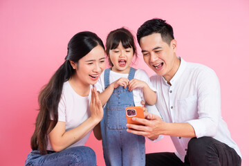 Wall Mural - young asian family image isolated on pink background