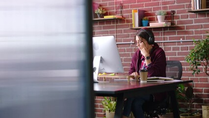 Aufkleber - Woman, headphones and computer in office, writing ideas or planning strategy. Startup, business employee and female from Canada listening to music, podcast or radio while working on marketing brand.