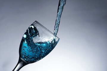 image of pouring water into a glass