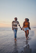 © Siphosethu F/peopleimages.com - Travel, beach and couple walking in the sea, laughing and bonding on an ocean trip. Freedom, love and romance with black woman and man enjoy conversation and funny joke while holding hands in water