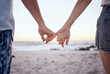 © Siphosethu F/peopleimages.com - Love, couple and holding hands on beach and sand for relationship, anniversary and embrace while on holiday together. Romance, man and woman happy, loving and bonding with sunset on vacation and trip
