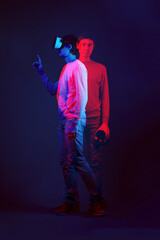 Wall Mural - man is using virtual reality headset. image with double color exposure effect.