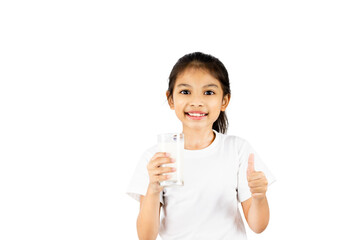 A young Asian girl wear a white T-shirt is smiling. His right hand holds a glass of milk and his left-hand thumbs up with clipping path.