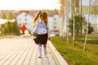 © Ruslan Ivantsov - a little girl goes to school through the park along the path.