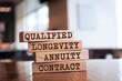 Wooden blocks with words 'Qualified Longevity Annuity Contract'. 