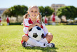 © N Lawrenson/peopleimages.com - Soccer ball, sports girl and field sitting, training for youth competition match playing at stadium grass. Portrait, young athlete or player enjoy youth football world cup championship game at club