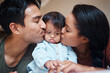© N Lawrenson/peopleimages.com - Love, disability and down syndrome parents kiss special needs kid with appreciation. Mom, dad and disabled baby in Puerto Rico home with happy and caring family bonding together.