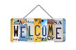 Welcome sign created with used recycled license plates isolated on trnasparent background