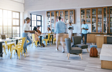 Wall Mural - Creative campus, busy library and students studying, research or working in community workspace with morning lens flare. People with education school books, reading information in college motion blur