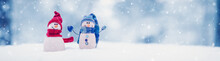 Little Knitted Snowmen On The White Snow On Blue Background.
