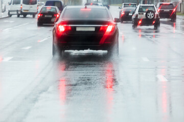 Wall Mural - rainy road. driving cars on a wet street with splashing water in motion blur.