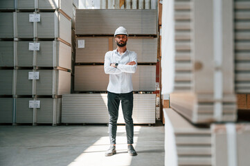 Wall Mural - Serious manager in formal clothes. Storage worker is in the warehouse with bunch of products