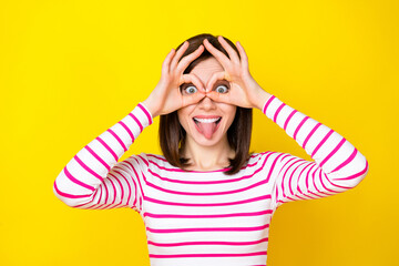 Sticker - Photo portrait of pretty young lady tongue out fingers show okey glasses dressed stylish striped outfit isolated on yellow color background