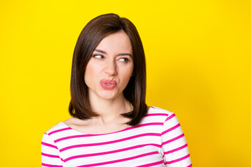 Wall Mural - closeup photo of young attractive nice woman looking empty space suspicious isolated on yellow color