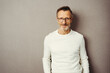 © contrastwerkstatt - Confident middle-aged man in standing against brown background with copy space and looking at camera