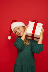 Wall Mural - Smiling funny child (kid, girl)  holding Christmas gift box