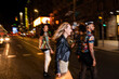 © ADDICTIVE STOCK - Diverse smiling friends walking on street at night