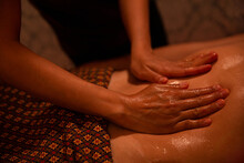 Hands Of Masseur Spreading Massage Oil To A Client