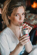 © ADDICTIVE STOCK - Attractive woman drinking through tube from soda can