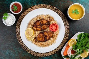 Arabian Sheri fish mandi rice with lemon slice served in dish top view of middle east food