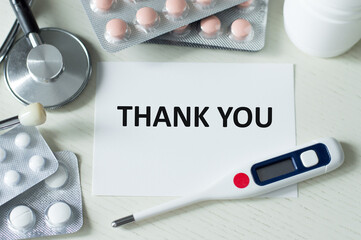 Wall Mural - Thank you text on a card on a table with lekartvas