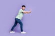 © deagreez - Full body photo of attractive young guy pushing hard copyspace difficult wear trendy gray clothes isolated on violet color background