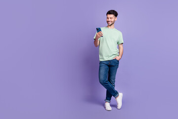Poster - Full length photo of nice young guy hold gadget apple samsung google user wear trendy gray clothes isolated on violet color background