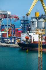 Wall Mural - industrial seaport infrastructure, sea, cranes and dry cargo ship, grain silo and bulk carrier vessel, concept of sea cargo transportation