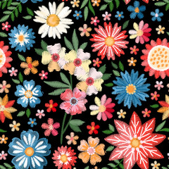 Wall Mural - Colorful seamless pattern with embroidered flowers. Vivid embroidery on black background. Fabric print with bright floral motifs