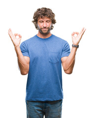 Sticker - Handsome hispanic model man over isolated background relax and smiling with eyes closed doing meditation gesture with fingers. Yoga concept.