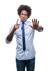 Poster - Afro american man holding credit card over isolated background with open hand doing stop sign with serious and confident expression, defense gesture