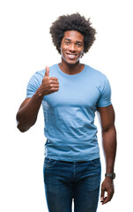 Afro american man over isolated background doing happy thumbs up gesture with hand. Approving expression looking at the camera with showing success.