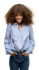 Poster - African american woman wearing a stripes shirt with a happy face standing and smiling with a confident smile showing teeth