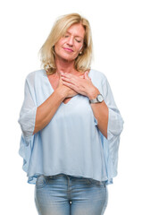 Sticker - Middle age blonde business woman over isolated background smiling with hands on chest with closed eyes and grateful gesture on face. Health concept.