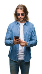 Poster - Young handsome man with long hair over isolated background sending message using smartphone with a confident expression on smart face thinking serious