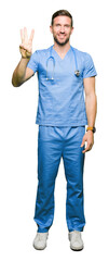 Canvas Print - Handsome doctor man wearing medical uniform over isolated background showing and pointing up with fingers number three while smiling confident and happy.